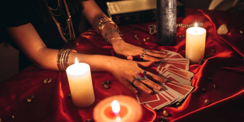 Young female fortune teller reading tarot.